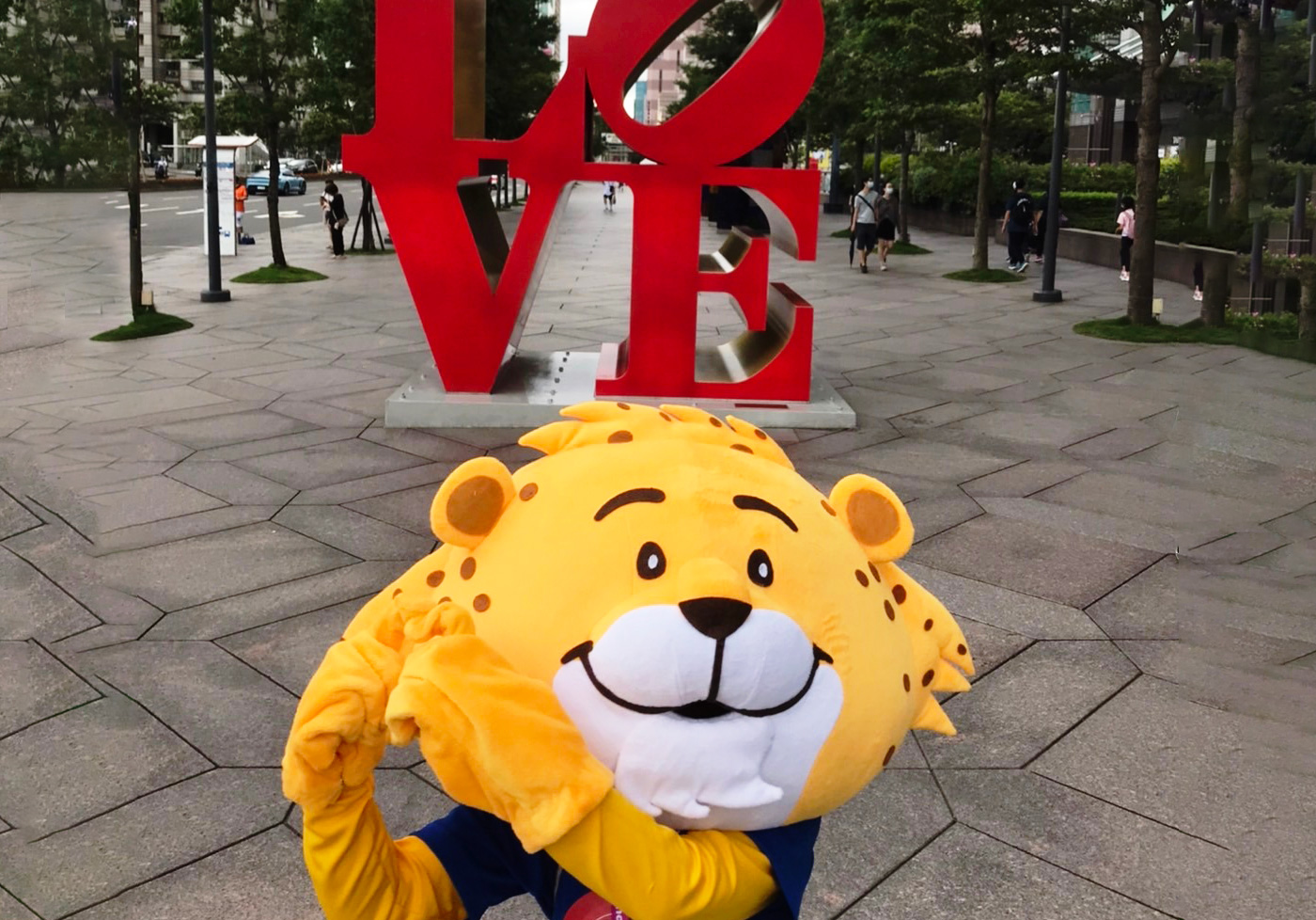Big Bear mascot in front of LOVE sculpture